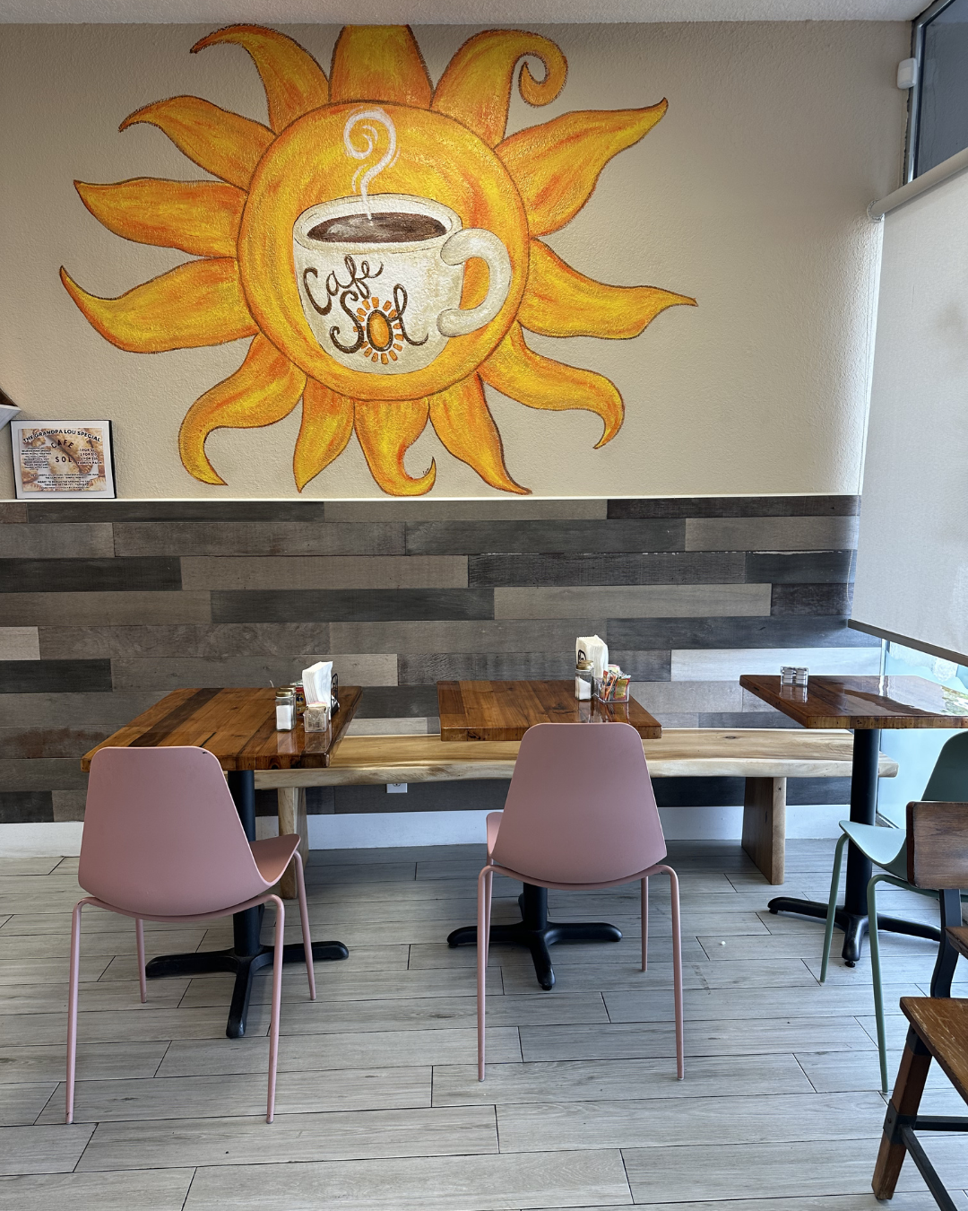 Hand-painted sun mural inside Cafe Sol